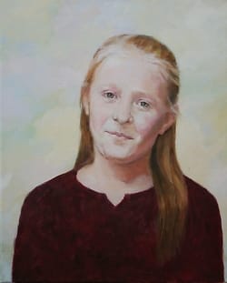 Portret van glimlachend meisje met loshangend rood haar.